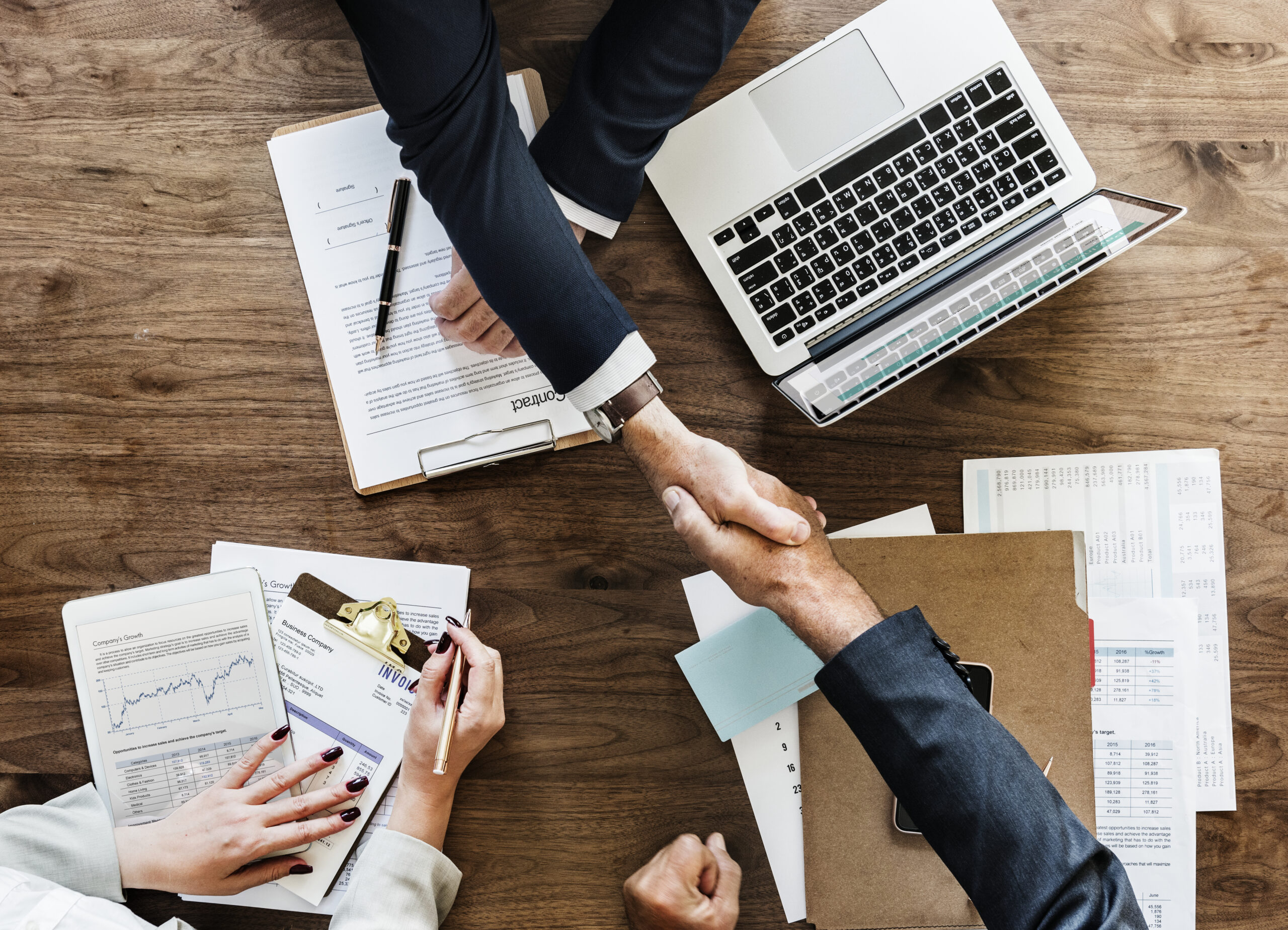 business people shaking hands together scaled